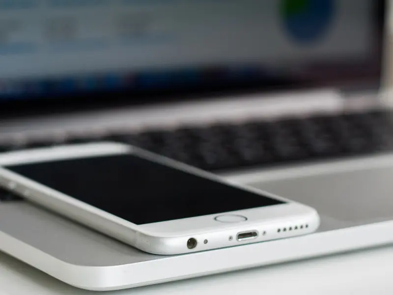 Smartphone resting on a laptop